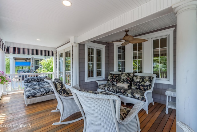 wooden terrace with a ceiling fan and covered porch