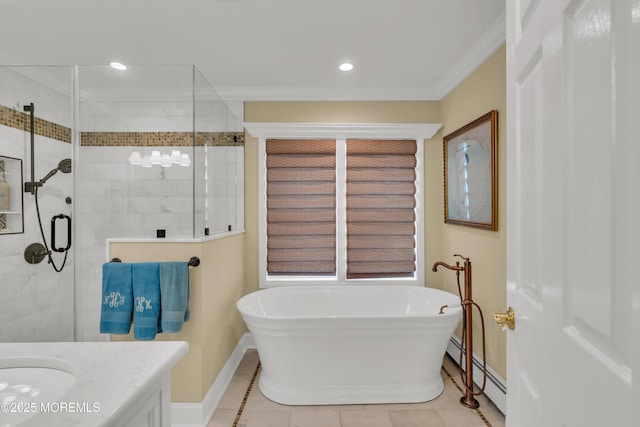 full bathroom featuring a stall shower, ornamental molding, vanity, a freestanding tub, and a baseboard heating unit