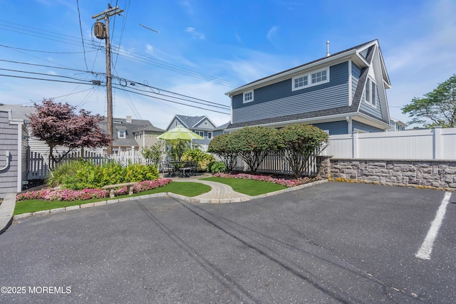 view of front of property with a patio area and fence