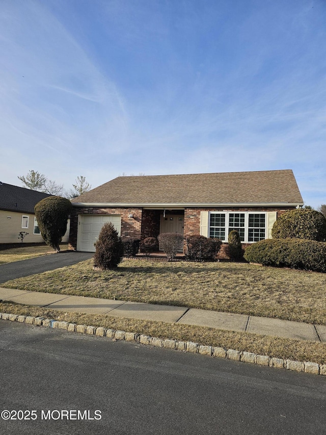 ranch-style house with aphalt driveway, brick siding, a shingled roof, and an attached garage