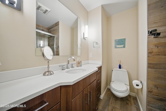 full bath with toilet, wood finished floors, visible vents, vanity, and a shower stall