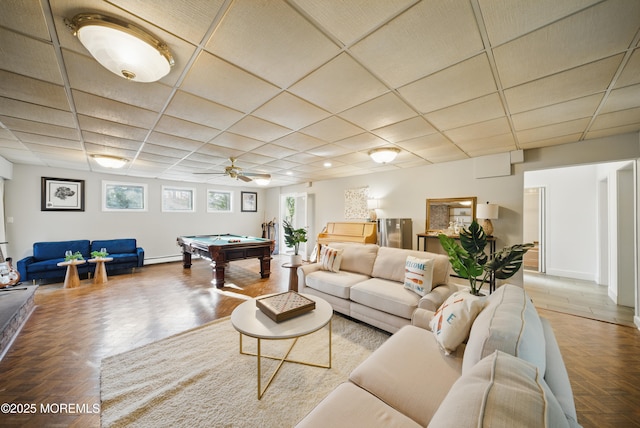 living area with a paneled ceiling, billiards, and baseboards