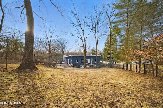 back of property featuring fence and a deck