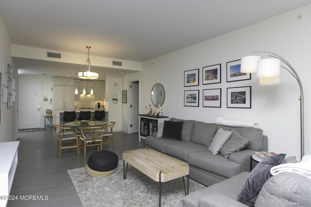 living area featuring wood finished floors and visible vents