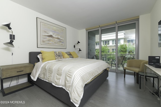 bedroom with access to exterior, floor to ceiling windows, baseboards, and wood finished floors