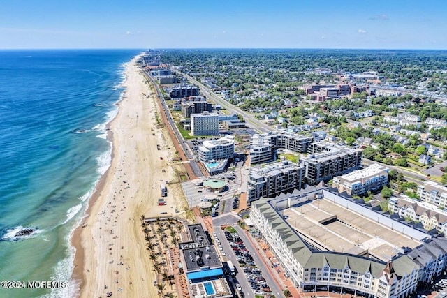 birds eye view of property with a water view and a view of the beach