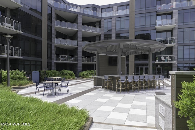 view of home's community with a patio, outdoor dry bar, and a pergola