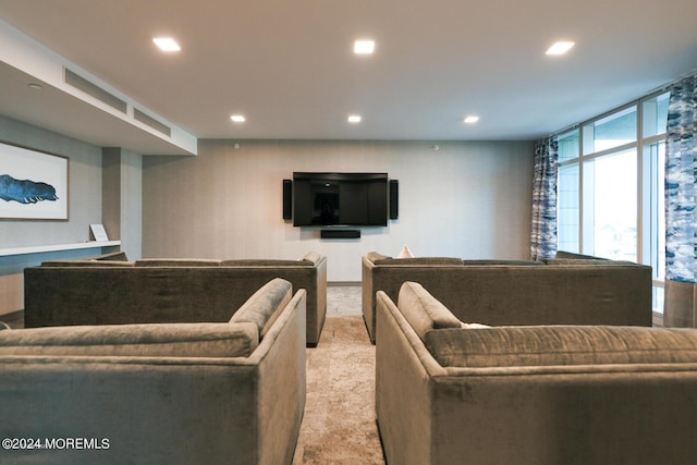 living room with recessed lighting and light colored carpet