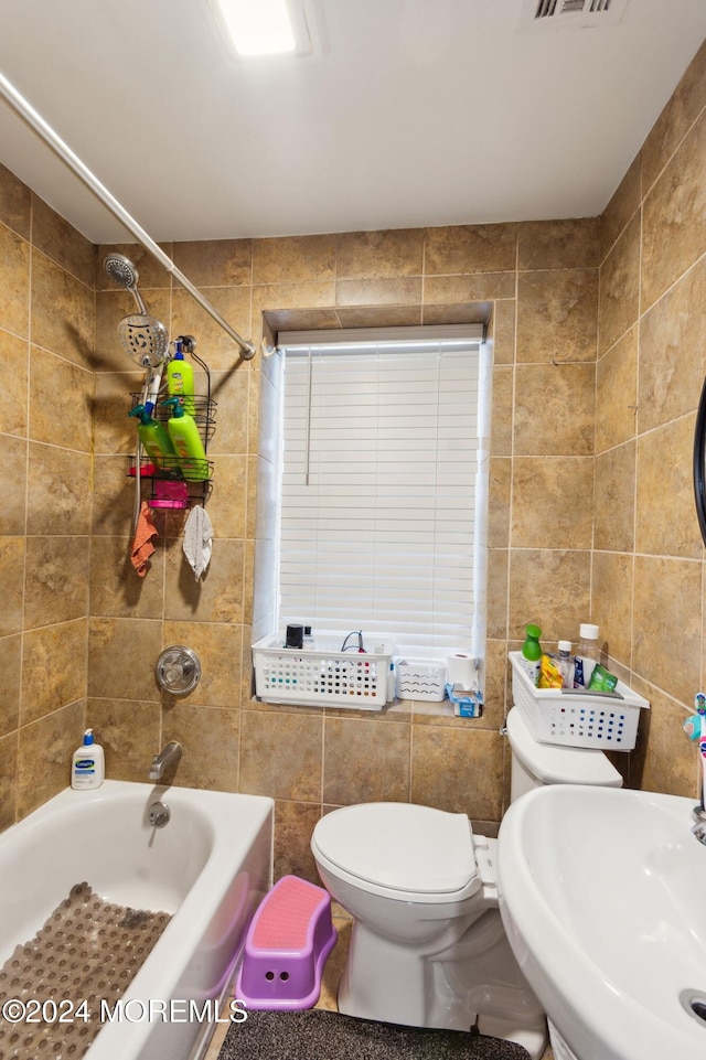 full bath featuring shower / bath combination, visible vents, tile walls, toilet, and a sink