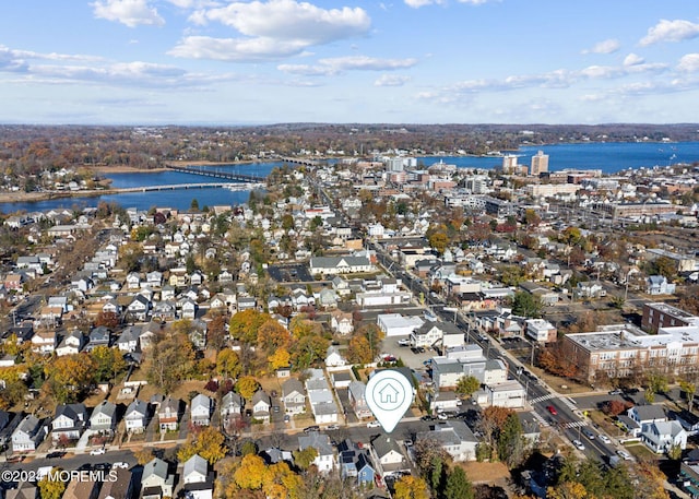 drone / aerial view featuring a water view and a residential view