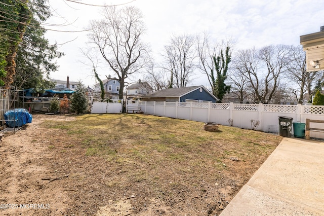 view of yard with an outdoor fire pit and a fenced backyard