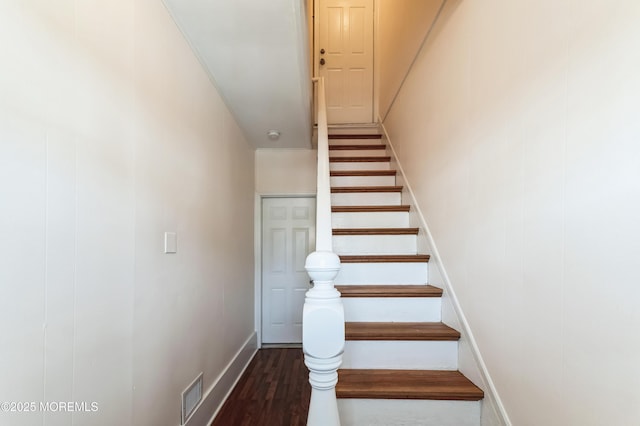 stairs with visible vents, baseboards, and wood finished floors