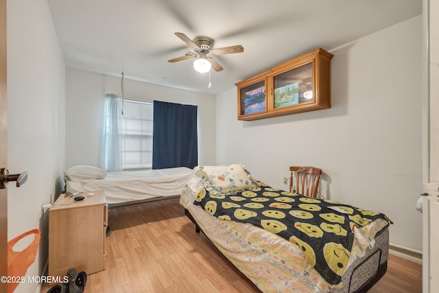 bedroom featuring ceiling fan and wood finished floors