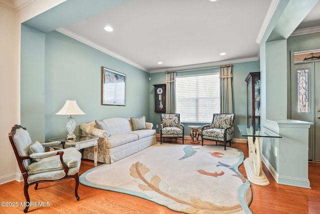 living area featuring recessed lighting, wood finished floors, baseboards, and ornamental molding