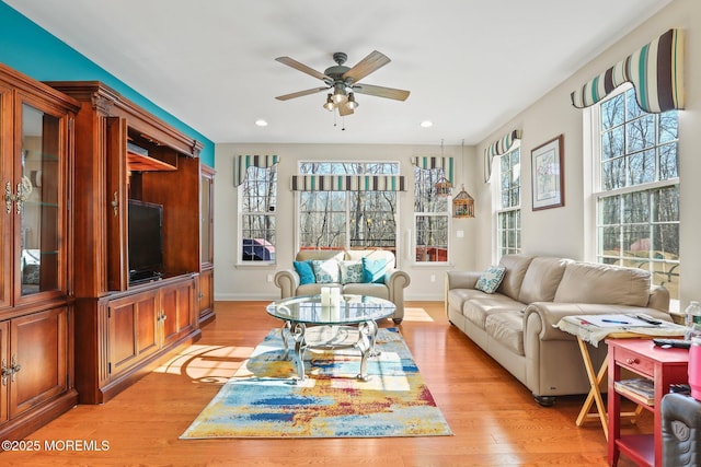 living room featuring recessed lighting, baseboards, light wood-type flooring, and a ceiling fan