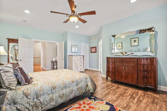 bedroom featuring visible vents, baseboards, recessed lighting, wood finished floors, and a ceiling fan