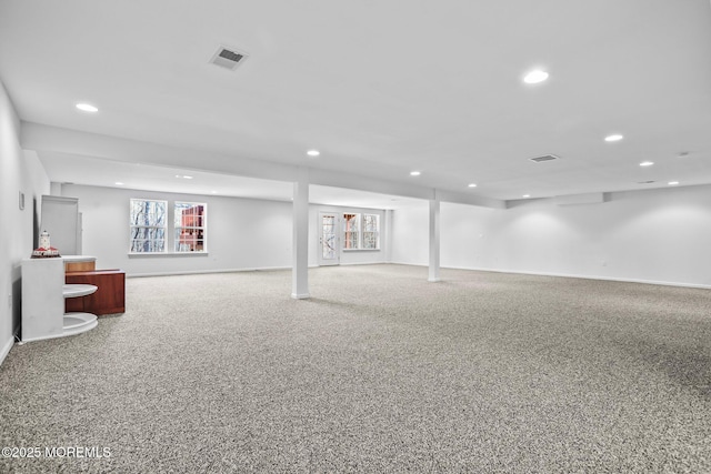 basement with carpet flooring, recessed lighting, and visible vents