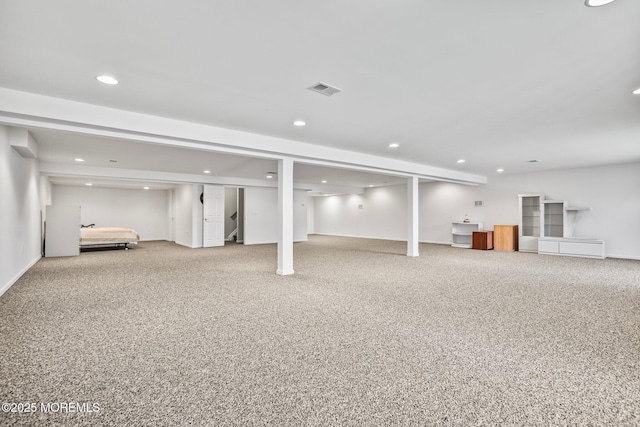 finished below grade area featuring carpet flooring, recessed lighting, and visible vents