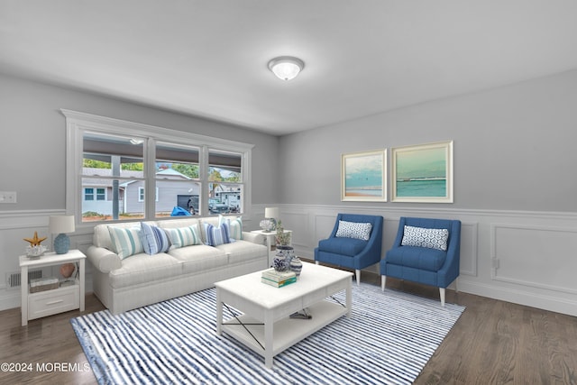 living room with visible vents, wood finished floors, and wainscoting