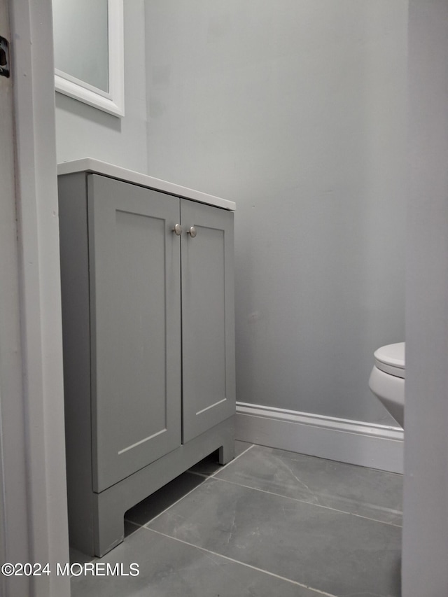 interior details featuring toilet and baseboards