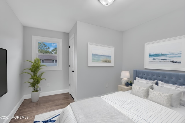 bedroom featuring wood finished floors and baseboards