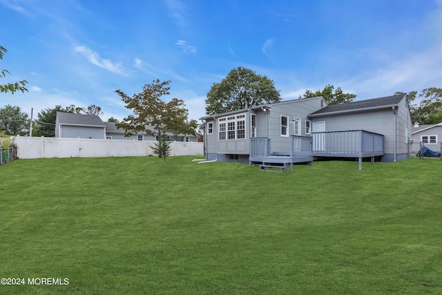 back of property with a yard, a fenced backyard, and a wooden deck