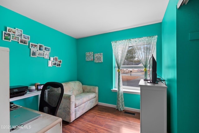 office area featuring dark wood-style floors, visible vents, and baseboards