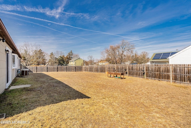 view of yard featuring central AC unit and a fenced backyard