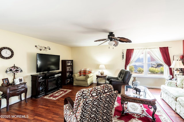 living room with ceiling fan, wood finished floors, and baseboards