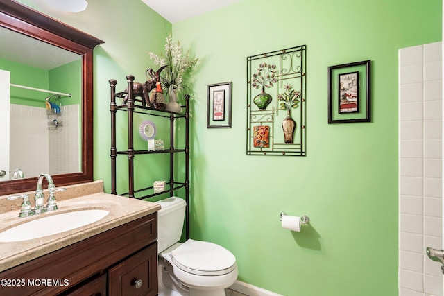 bathroom featuring vanity, walk in shower, and toilet