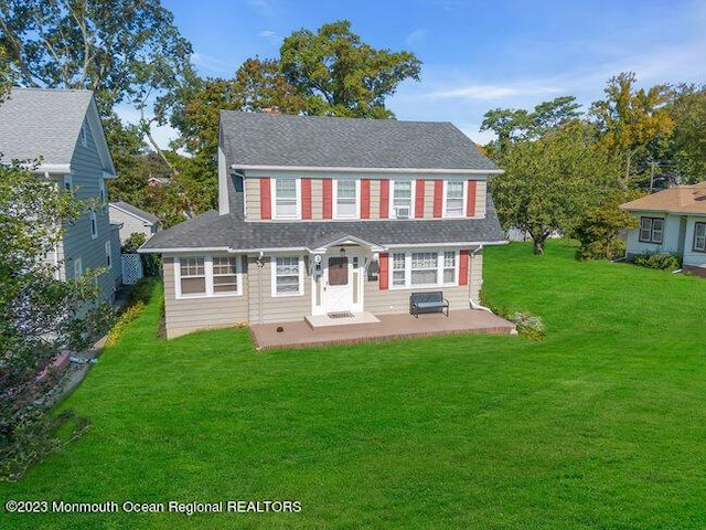 view of front of home with a front yard and a patio