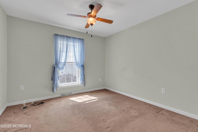 unfurnished room featuring baseboards, visible vents, carpet floors, and ceiling fan