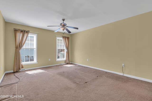 unfurnished room with carpet flooring, ceiling fan, visible vents, and baseboards