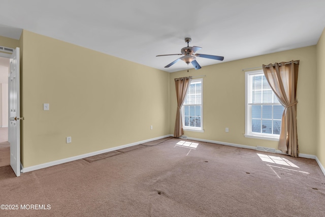 spare room featuring visible vents, baseboards, carpet floors, and ceiling fan