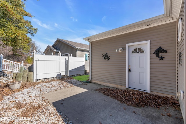 doorway to property featuring a patio area and fence