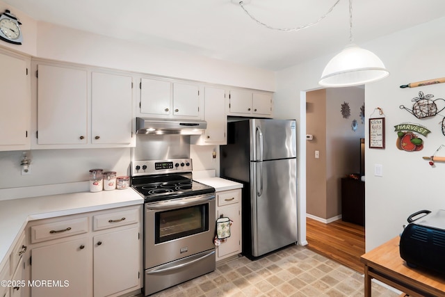 kitchen featuring under cabinet range hood, white cabinetry, stainless steel appliances, and light countertops