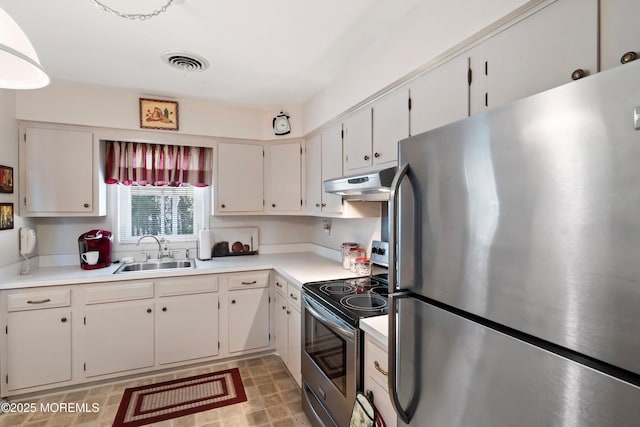 kitchen featuring stainless steel appliances, light countertops, visible vents, a sink, and under cabinet range hood