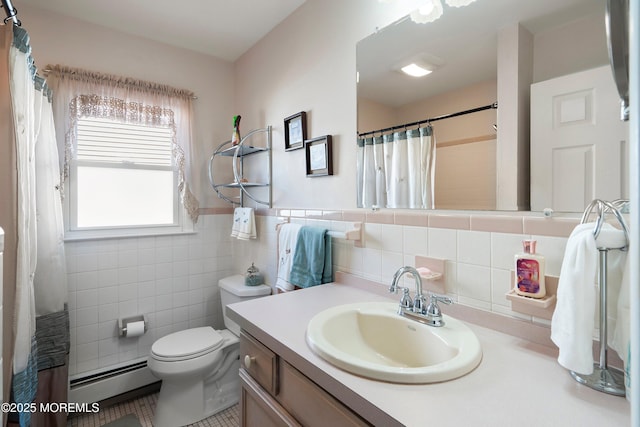 full bathroom with toilet, vanity, tile walls, baseboard heating, and wainscoting