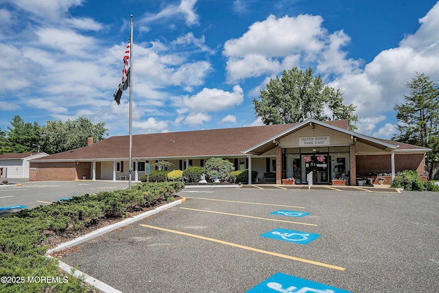 view of building exterior featuring uncovered parking