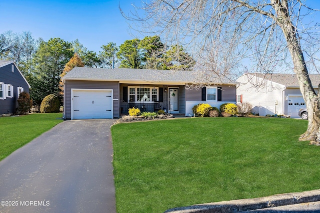 ranch-style house featuring a garage, aphalt driveway, and a front yard