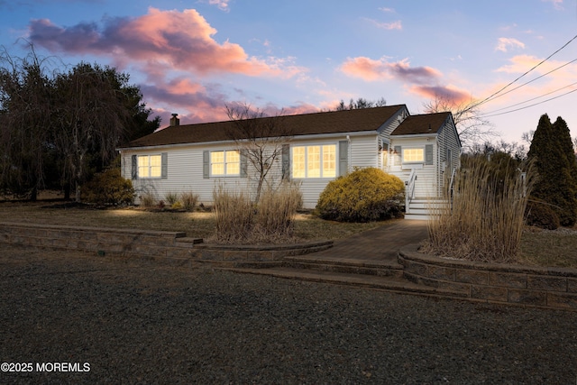 ranch-style home featuring a chimney