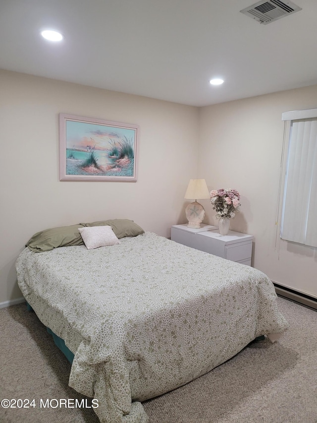 carpeted bedroom with baseboard heating, visible vents, and recessed lighting