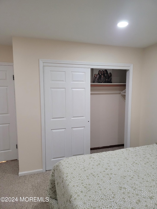 unfurnished bedroom with carpet floors, a closet, and baseboards