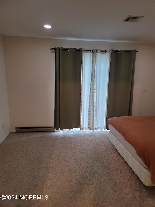 carpeted bedroom with recessed lighting, visible vents, and a baseboard radiator