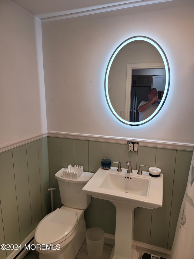 bathroom with toilet and wainscoting