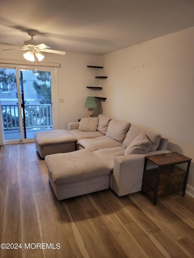 living room with a ceiling fan and wood finished floors