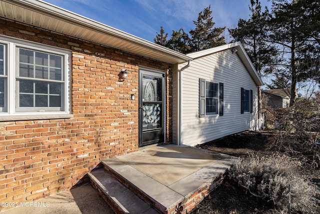 property entrance with brick siding