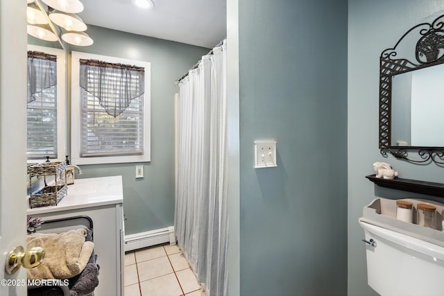 full bathroom with a baseboard radiator, a shower with shower curtain, toilet, vanity, and tile patterned floors