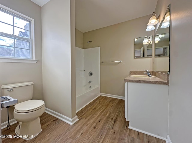 full bathroom with baseboards, vanity, toilet, and wood finished floors