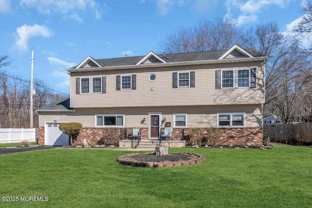 551 Chester Pkwy, Belford, NJ 07718 - view of front facade featuring a front lawn, aphalt driveway, fence, a garage, and brick siding